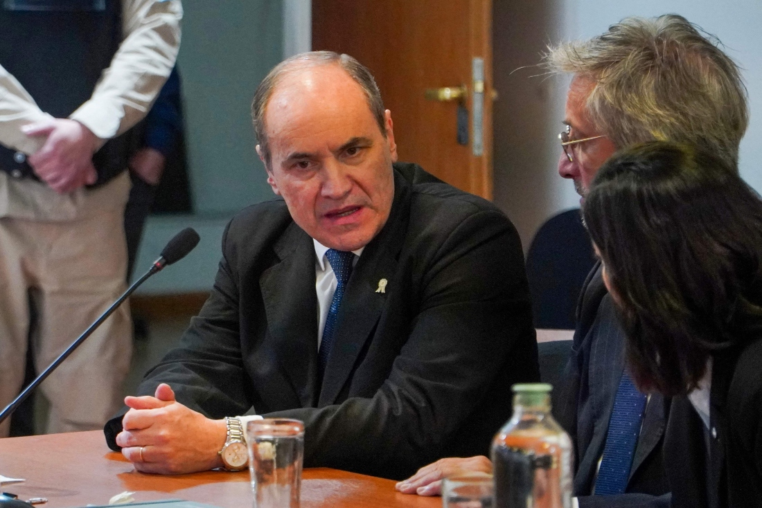 Former Navy commander Claudio Javier Villamide former chief of the Submarine Force Command, speaks with his lawyers during a sentencing hearing in Rio Gallegos, Santa Cruz province, Argentina. (AFP)