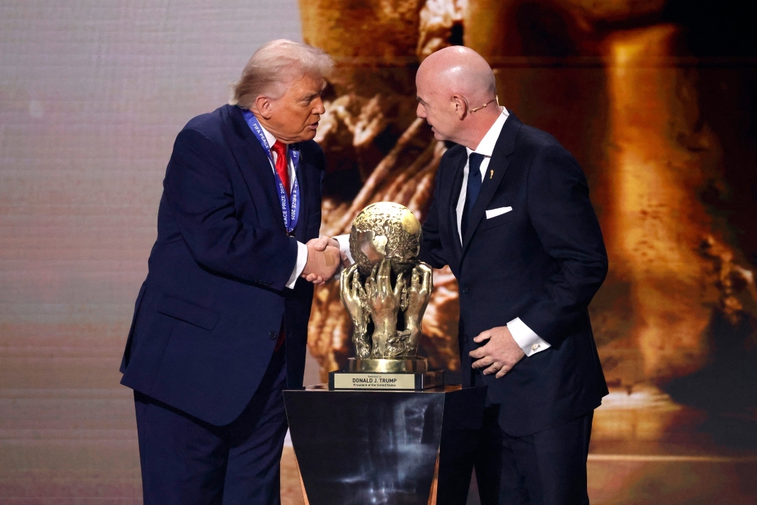 Dec 5, 2025; Washington, District of Columbia, USA; FIFA president Gianni Infantino presents United States president Donald Trump with the FIFA Peace Prize during the FIFA World Cup 2026 Final Draw at John F. Kennedy Center for the Performing Arts. (Amber Searls-Imagn Images)
