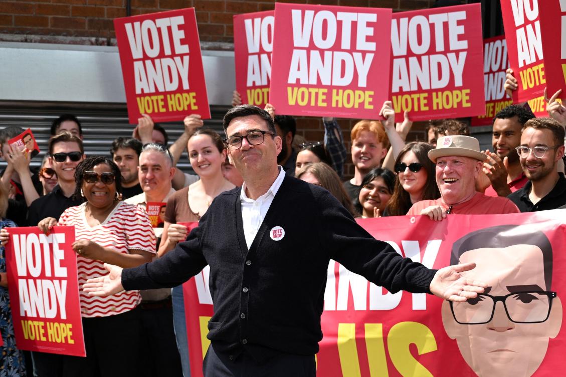 Britain's Labour party candidate Andy Burnham addresses supporters outside his party's campaign office in Ashton in Makerfield, northwest England, in June. (AFP file photo)