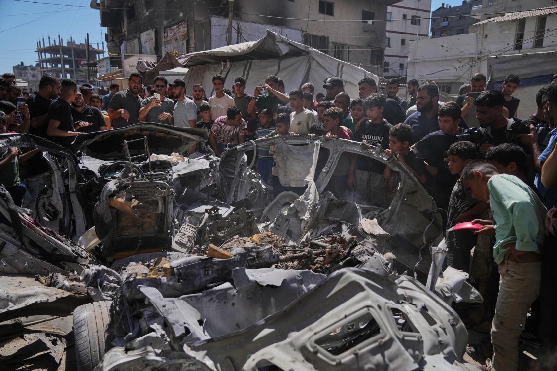 Palestinians gather around a car hit in an Israeli military strike that, according to health authorities, killed at least one person in Gaza City, Jul. 9, 2026. (AP)