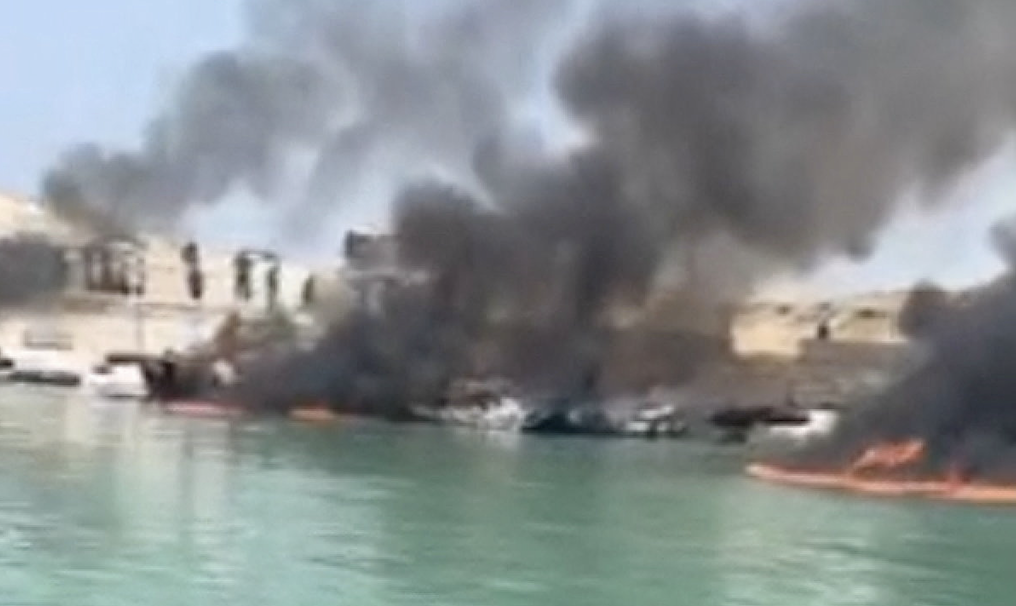Smoke rises from boats on fire at a fishing pier in Banood, Bushehr Province on July 9, 2026. (Reuters)