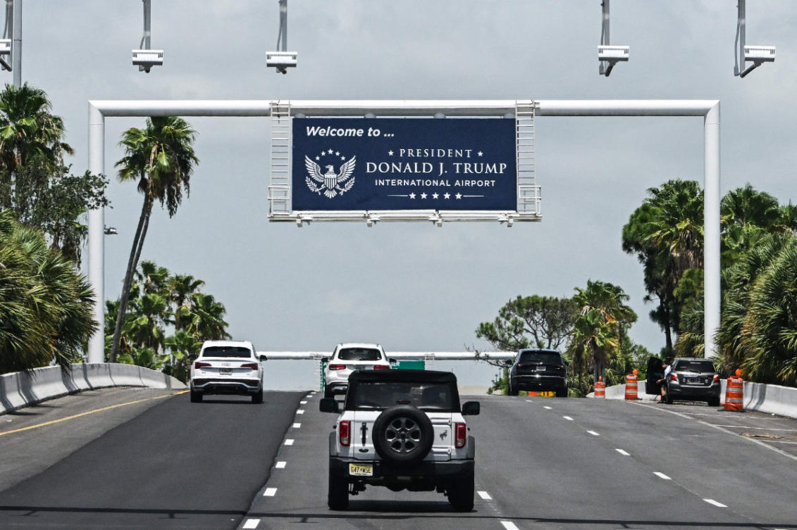 A new welcome sign reading "Donald J. Trump International Airport" is seen at the airport's main entrance ramp in West Palm Beach, Florida, on July 9, 2026. (AFP)