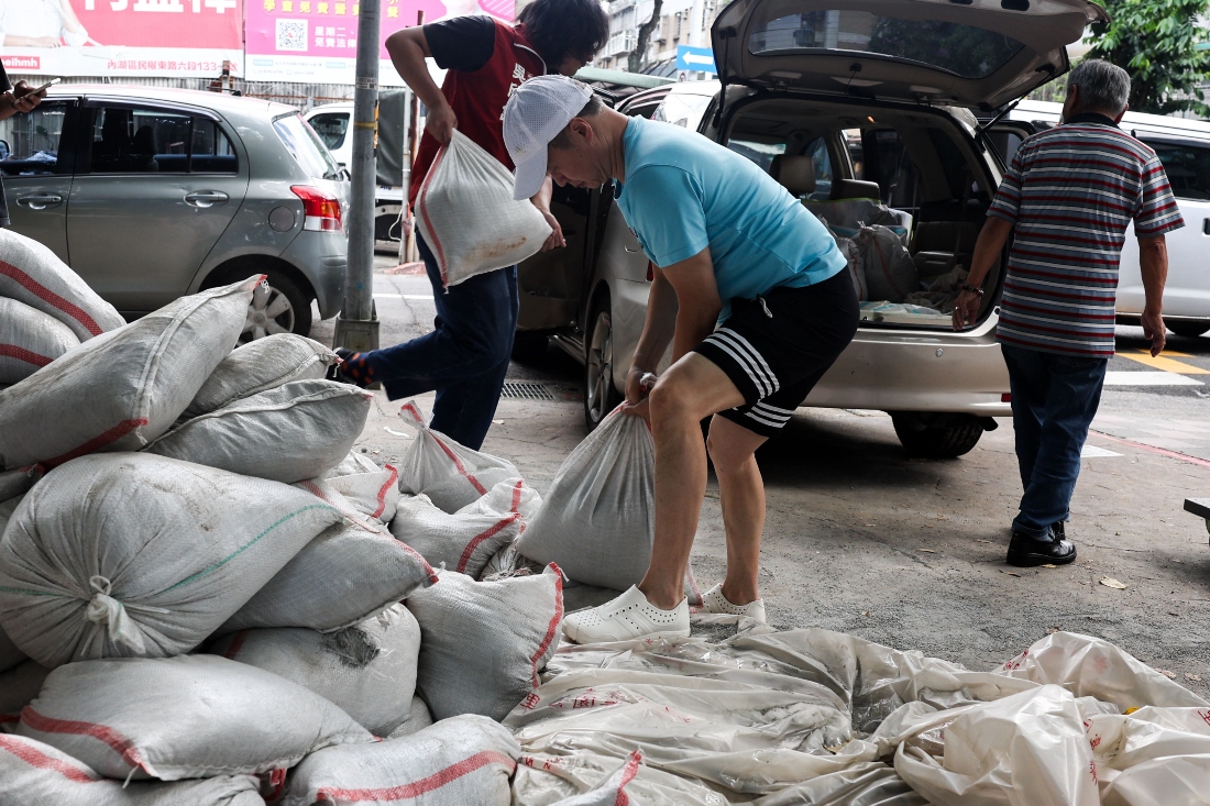 People load sandbags onto a truck as preparations are made ahead of the arrival of Typhoon Bavi, in Taipei, Taiwan. (AFP)
