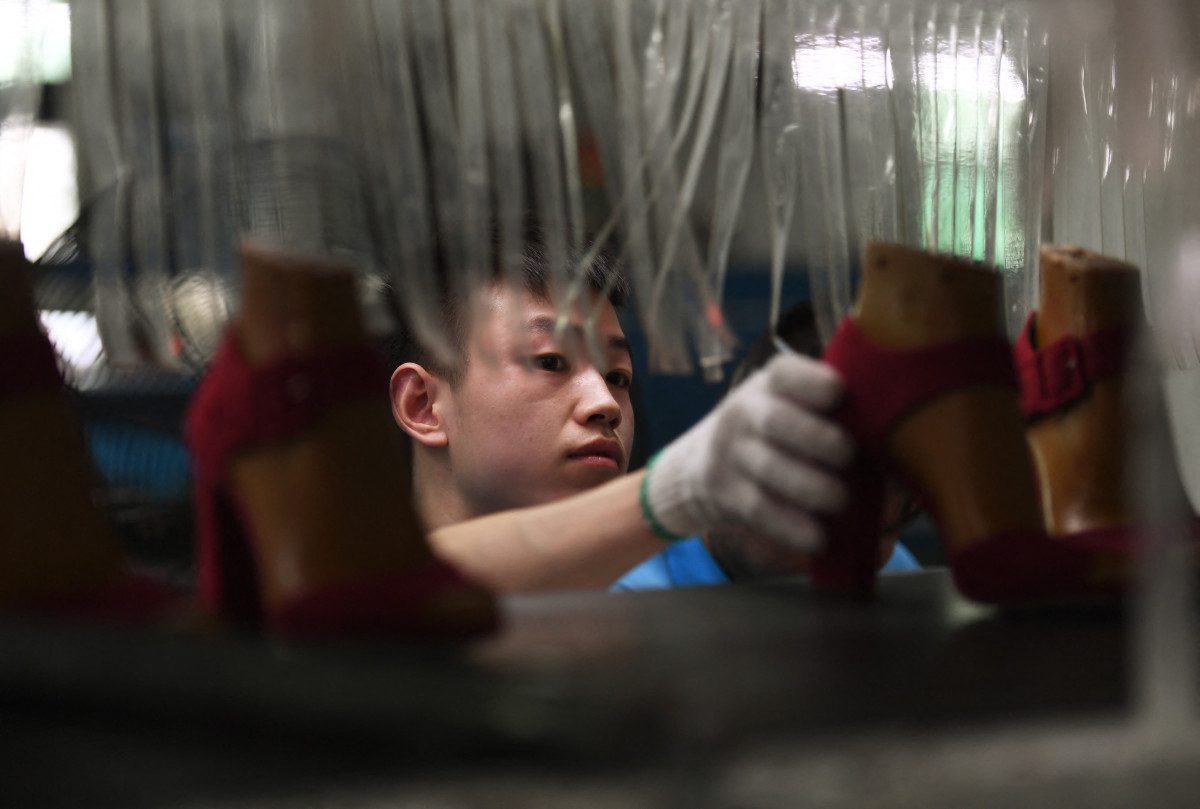 A worker on a production line at the Huajian shoe factory, China. (AFP)
