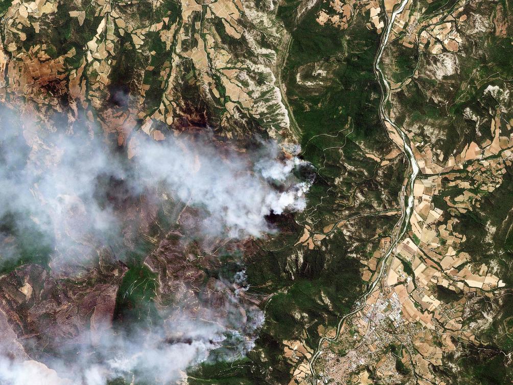 This handout satellite photograph taken on July 8, 2026 and released by 2026 Planet Labs PBC shows the smoke from a wildfire in a mountainaera near Die, southern France. (AFP)