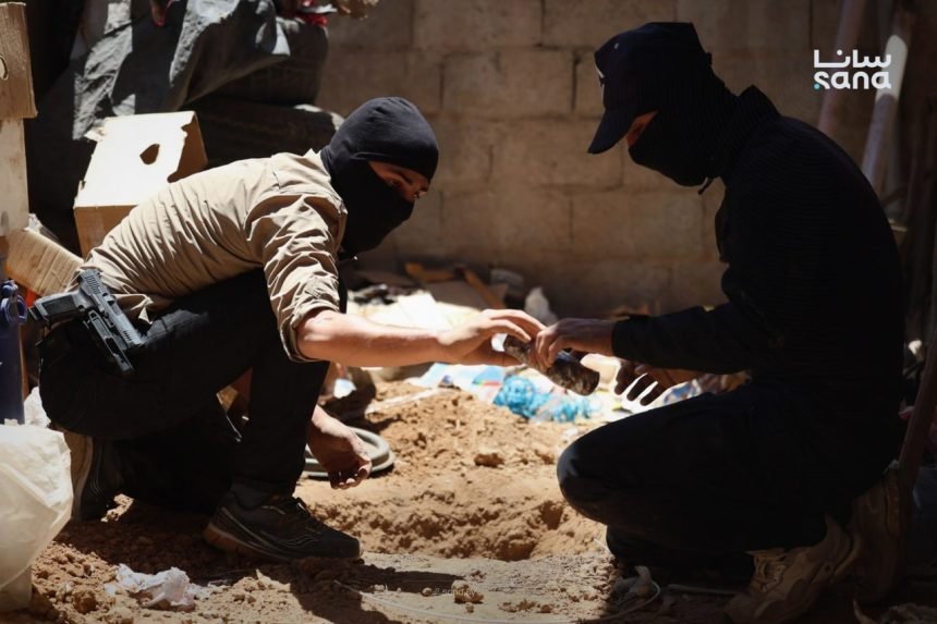 Syrian bomb disposal experts remove explosives from a site linked to the terrorist cell responsible for the Damascus bombings. (SANA photo)