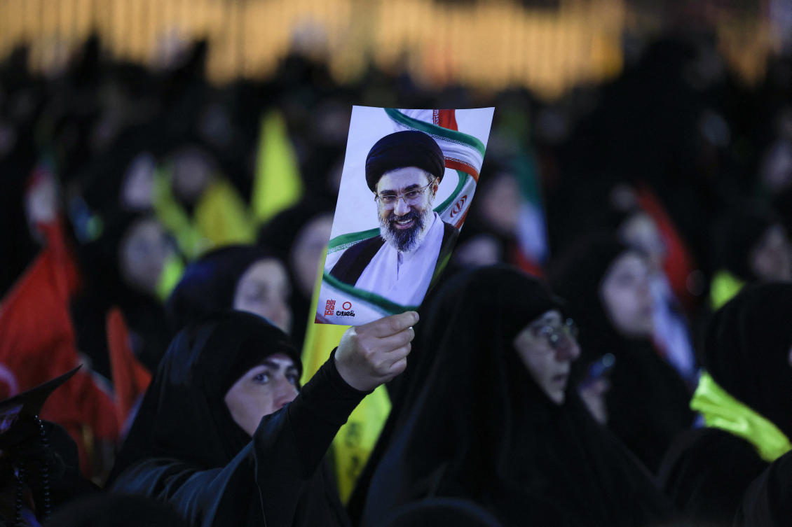 A person holds a portrait of Iran's Supreme Leader Mojtaba Khamenei, as people gather to mourn Iran's late Supreme Leader Ayatollah Ali Khamenei, who was killed on February 28 in Israeli and U.S. airstrikes, in the southern suburbs of Beirut, Lebanon, July 8, 2026. REUTERS/Mohamed Azakir
