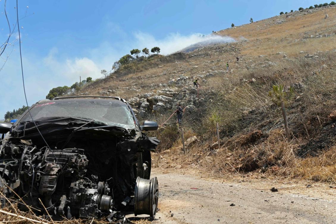 A vehicle damaged by an Israeli strike in the southern Lebanese village of Kfar Roummane on Friday. (AFP)