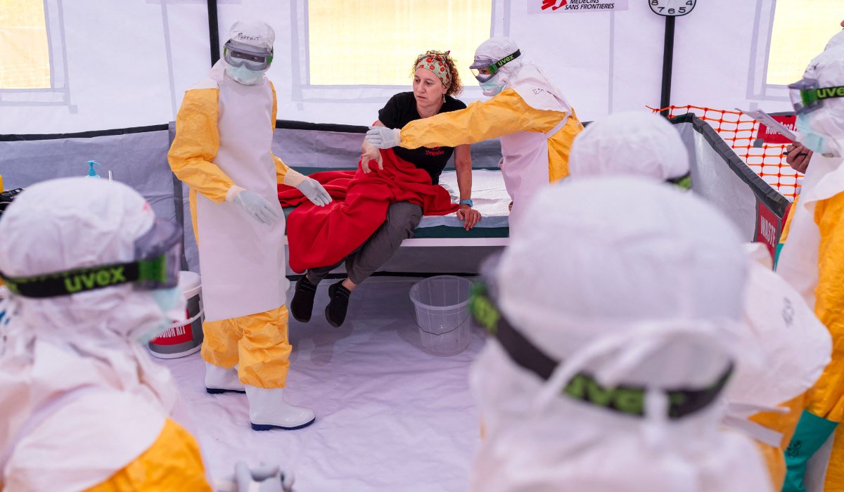 Health workers in Personal Protective Equipment (PPE) simulate with the help of an Outbreak Response Advisor admission protocols of suspected cases during a training in Kenya on July 10, 2026. (AFP)