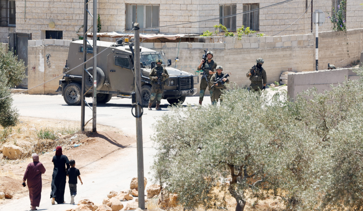 Members of the Israeli military take part in a raid, after settler attacks, in al-Mughayyir, in the Israeli-occupied West Bank, July 11, 2026. (REUTERS)