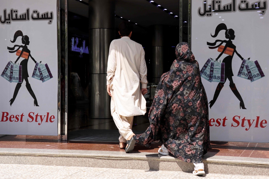 Afghan man and a woman entering a shopping centre in Herat, Afghanistan. (AFP)