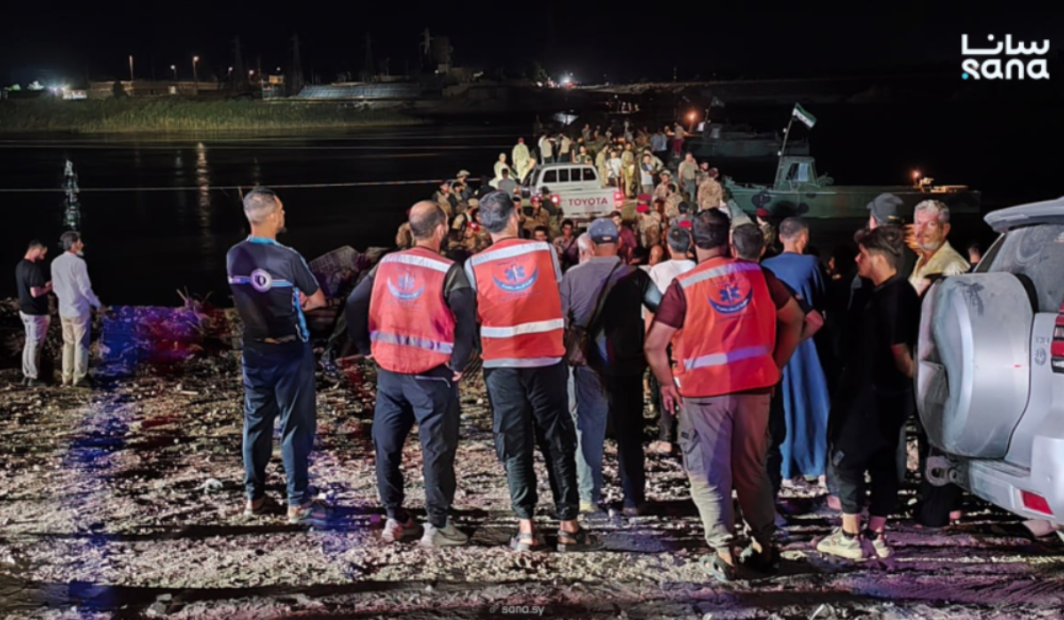 Syrian Civil Defense teams search for survivors after a ferry carrying civilians sank in the Euphrates River in Deir Ezzor. (SANA)