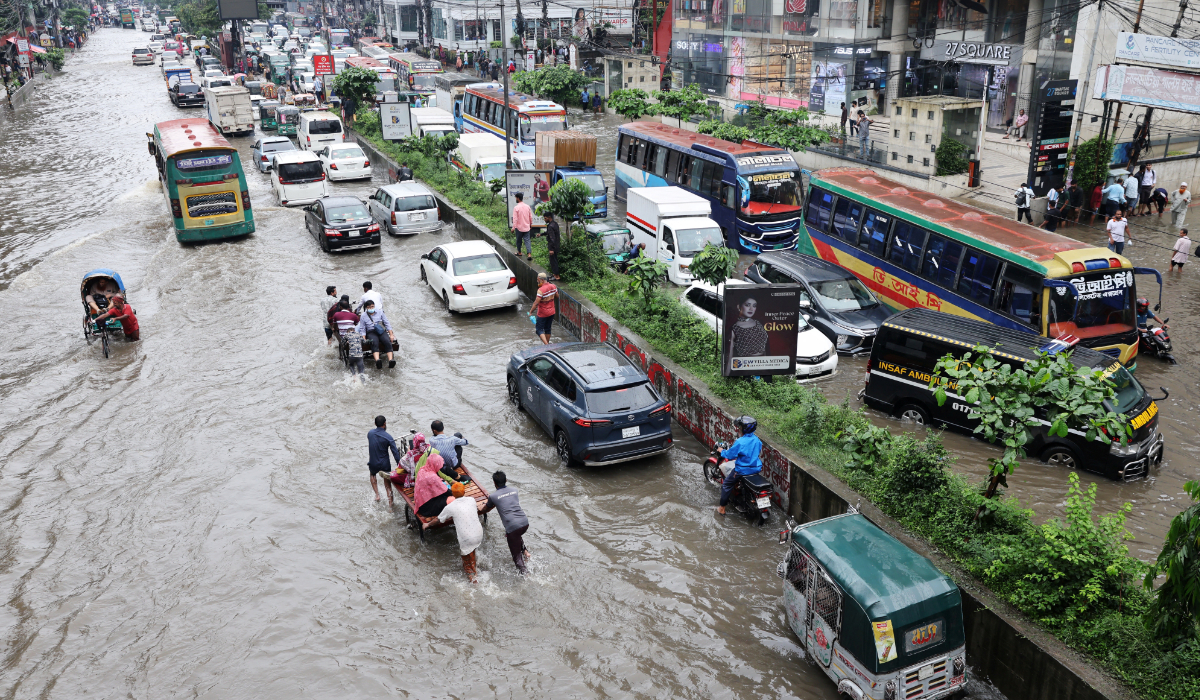 Vehicles move through a flooded street following torrential rain in Dhaka, Bangladesh, July 12, 2026. (REUTERS)