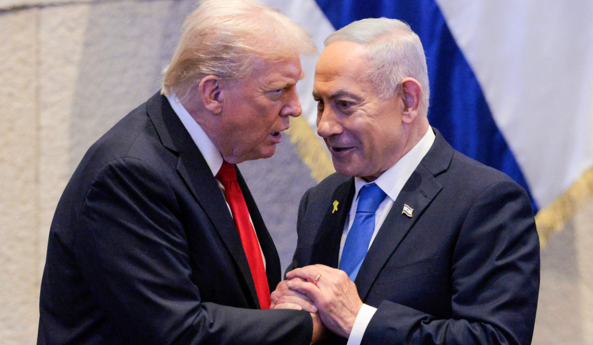 US President Donald Trump (L) holds hands and speaks with Israeli Prime Minister Benjamin Netanyahu at the Israeli parliament, the Knesset, in Jerusalem on October 13, 2025. (AFP)