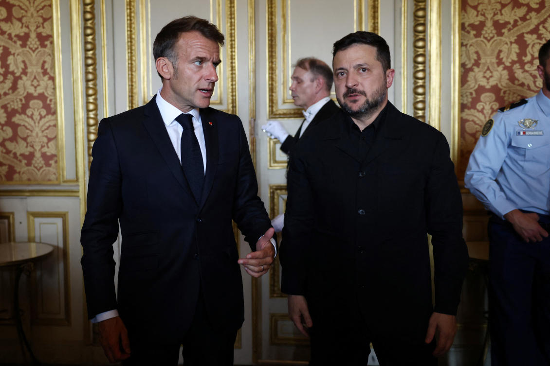 French President Emmanuel Macron (L) talks with Ukrainian President Volodymyr Zelenskiy as they leave after an Integrated Anti-Ballistic Missile Coalition meeting at the Quai d'Orsay in Paris. (REUTERS)