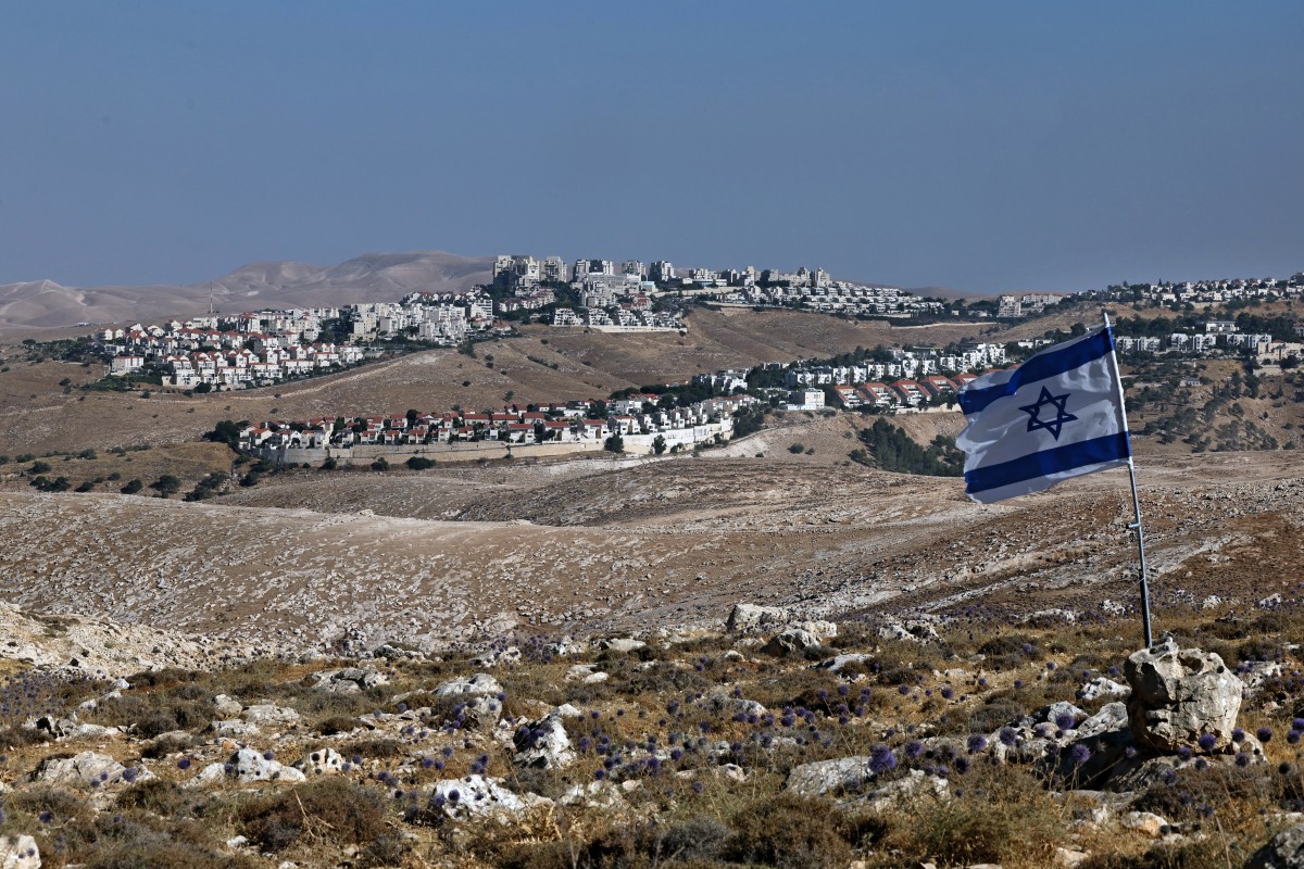 An Israeli flag flutters on a hill overlooking the Israeli settlement of Maale Adumim in the occupied West Bank on the outskirts of Jerusalem, Jun. 22, 2026. (AFP)
