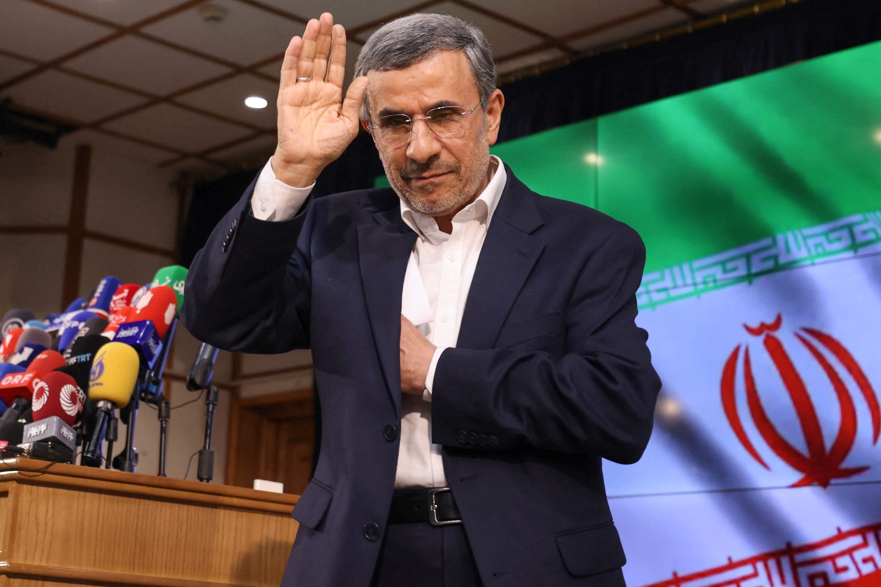Iranian former president Mahmoud Ahmadinejad waves after registering his candidacy for Iran’s upcoming presidential election in Tehran, June 2, 2024. (AFP)