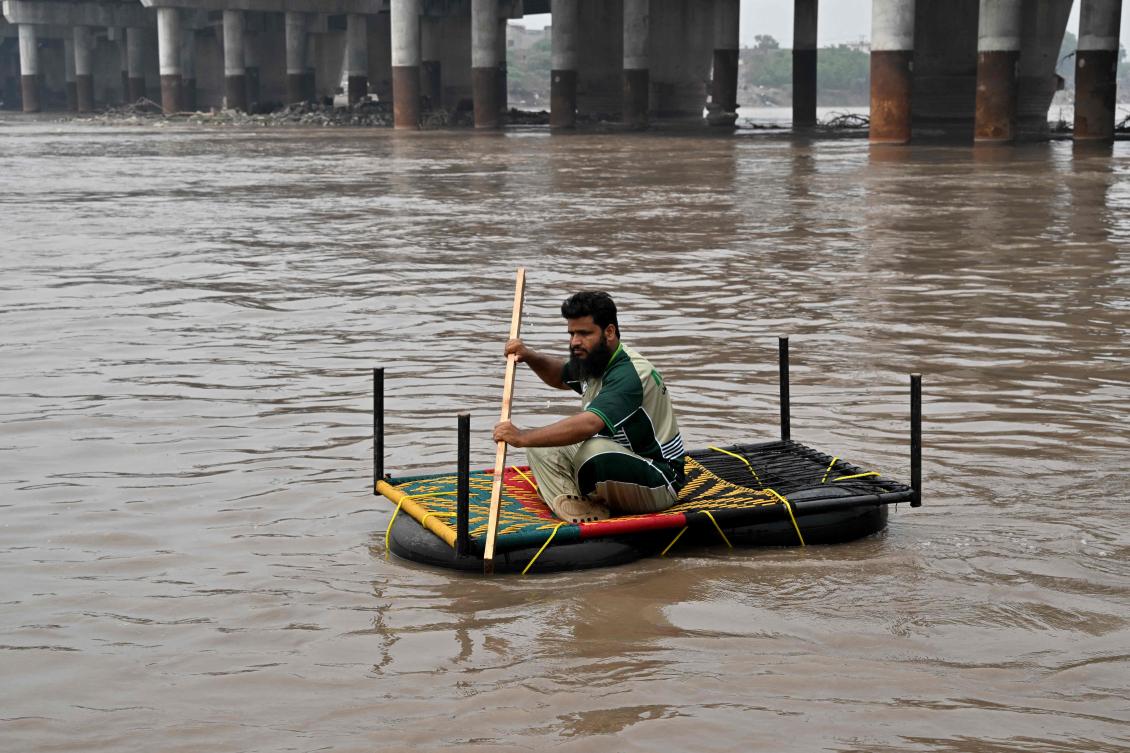 Relief personnel conduct a flood rescue drill during monsoon season as a precautionary measure at the Ravi river in Lahore on July 13, 2026. (AFP)