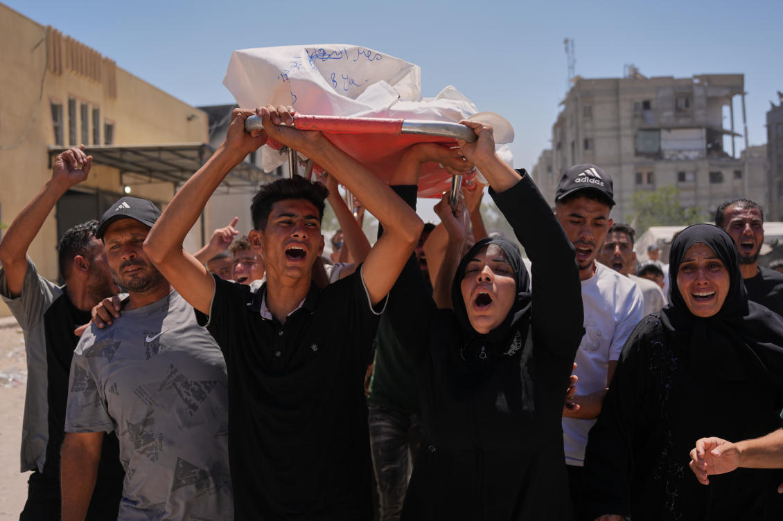 Warda Abu Shaar, center right, carries the body of her 10-year-old son, Motaz Abu Shaar, who was killed by Israeli fire, during his funeral outside Nasser Hospital in Khan Younis, southern Gaza Strip, Tuesday, July 14, 2026. (AP)