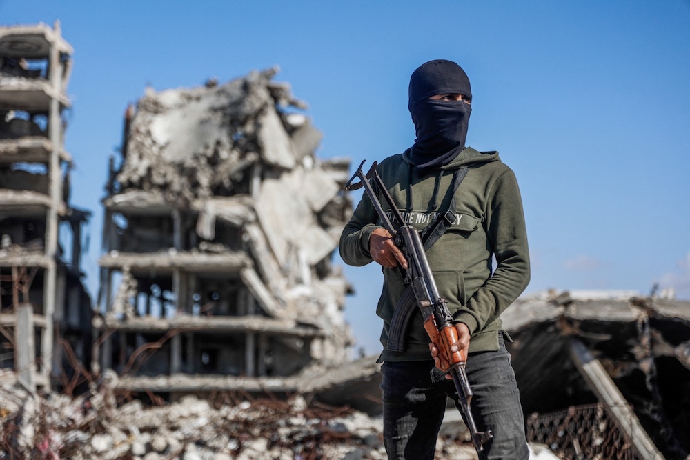 Analysts say Hamas’ announcement is intended to pave the way for a technocratic administration, while leaving the group’s military wing intact. (AFP)