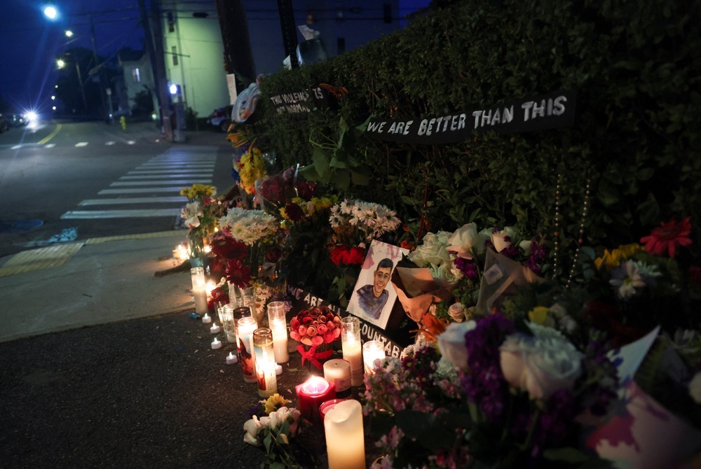 Flowers and a portrait with writing that reads “Joan Sebastian Guerrero” sit at a makeshift street-side memorial, a day after US Immigration and Customs Enforcement (ICE) agents fatally shot a driver, in Biddeford, Maine, U.S., July 14, 2026. (Reuters)