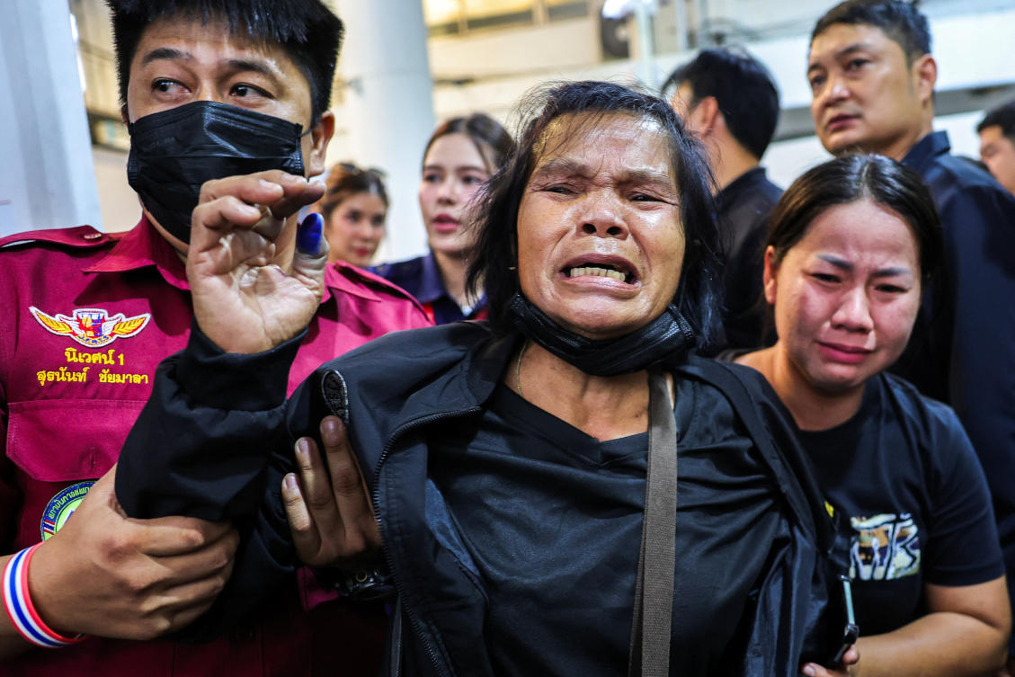 Family members react as they receive the body of a victim at the Police Hospital morgue, following a deadly fire at a pub in Bangkok, Thailand on July 14, 2026. (Reuters)