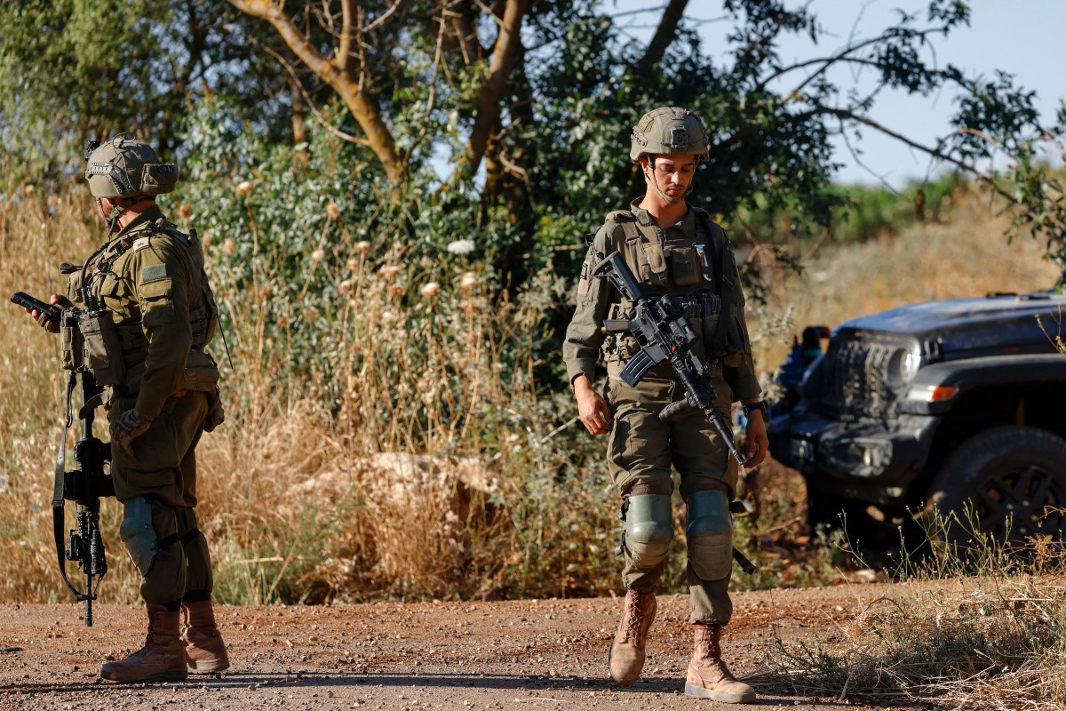 Israeli army soldiers patrol along the northern road near Moshav Margaliot in the Upper Galilee bordering Lebanon. (AFP)