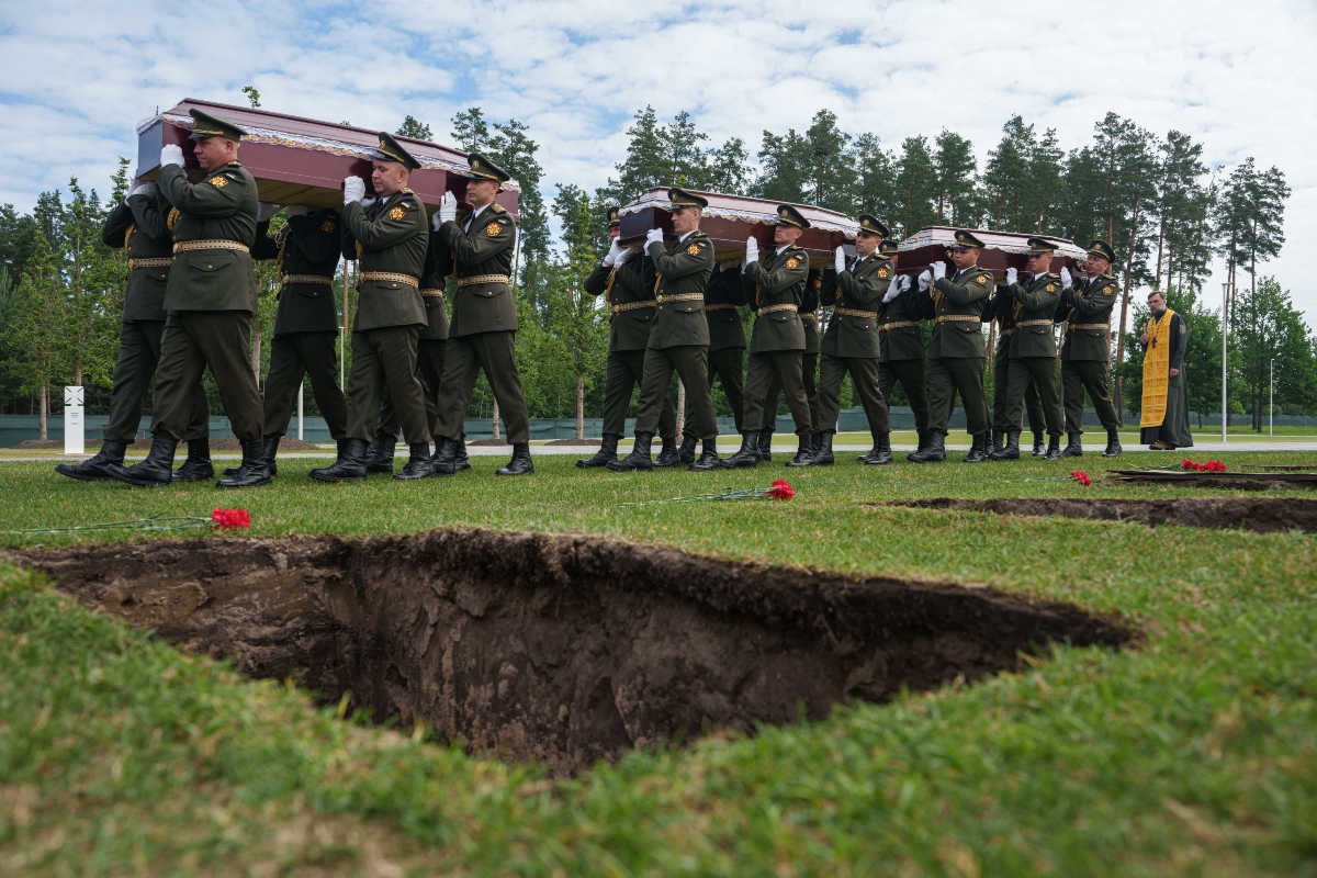 An honor guard carries the coffins of unidentified Ukrainian soldiers killed in battle during the Russian-Ukrainian war, during a funeral ceremony at a military cemetery near Kyiv, Ukraine. (AP)