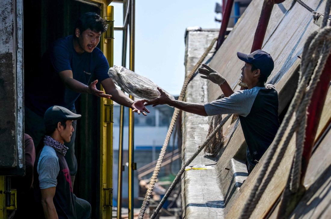 Crew members unloading their catch at the Nusantara Fishing Port in Kejawan-Cirebon, West Java, Indonesia. (AFP)