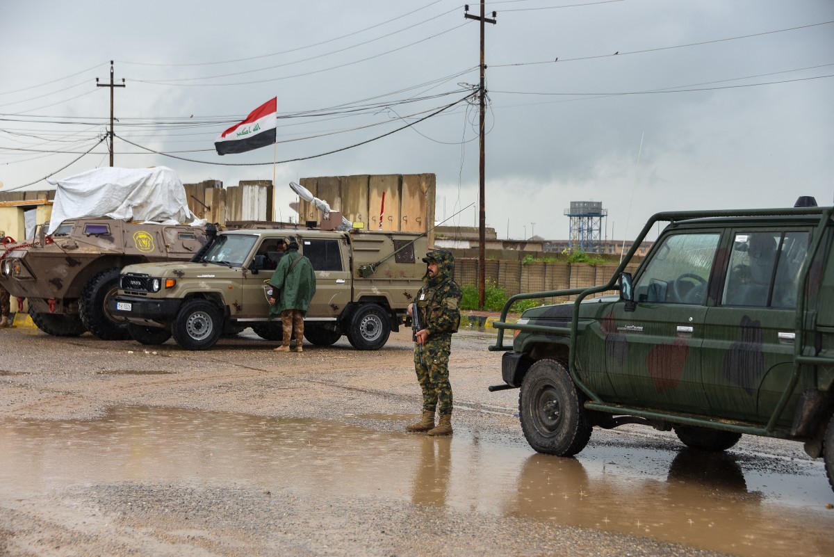 Members of Iraq's security forces stand guard on the the al-Rabia border crossing with Syria. (AFP)