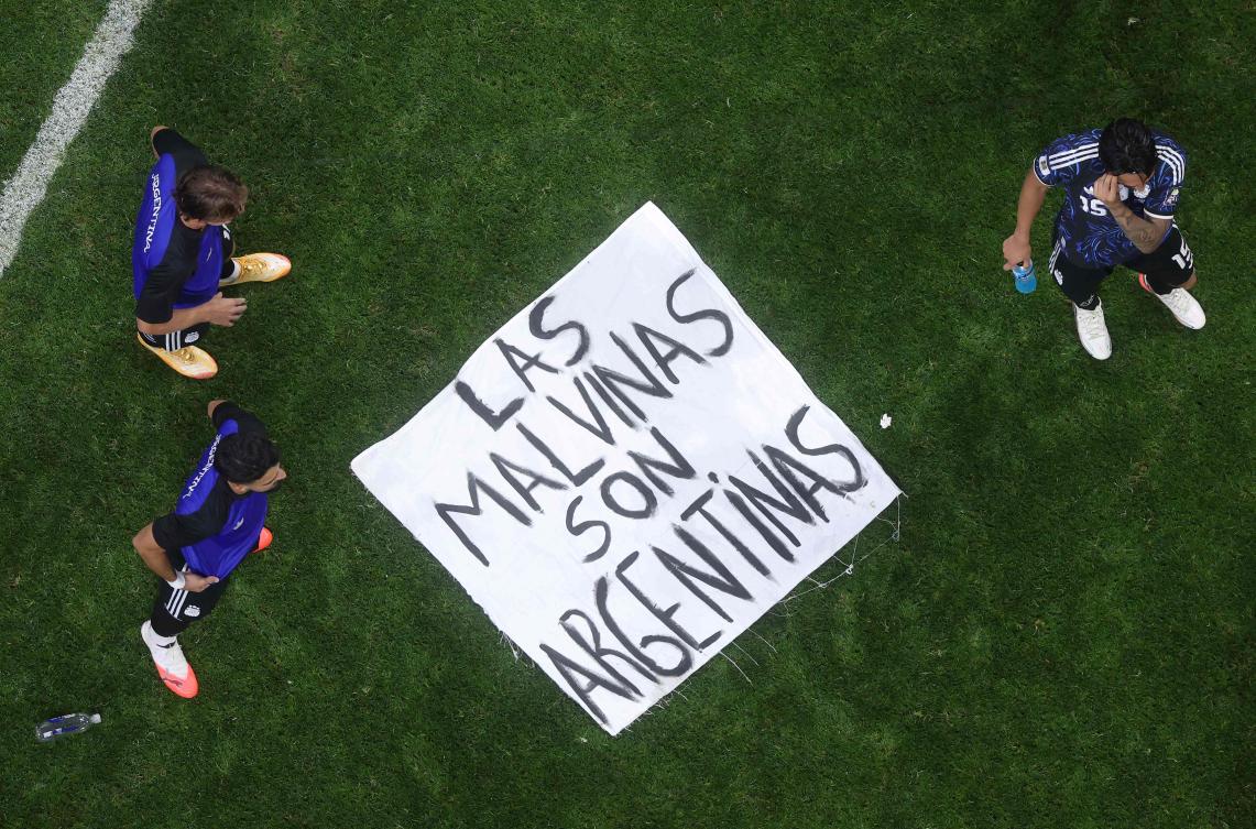 A banner referring to the Falkland Islands is seen on the pitch following Argentina’s 2-1 win during the FIFA World Cup 2026 semi-final match between England and Argentina on July 15, 2026. (Getty Images via AFP)