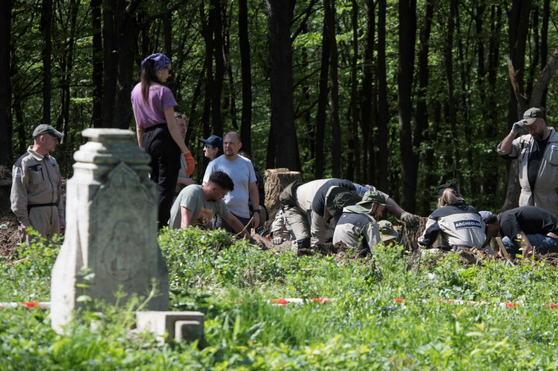 Above, Polish archaeologists work at the exhumation site of the World War II Volhynia massacre near the destroyed village of Puzniki, Ternopil region, on April 25, 2025. (AFP file photo)