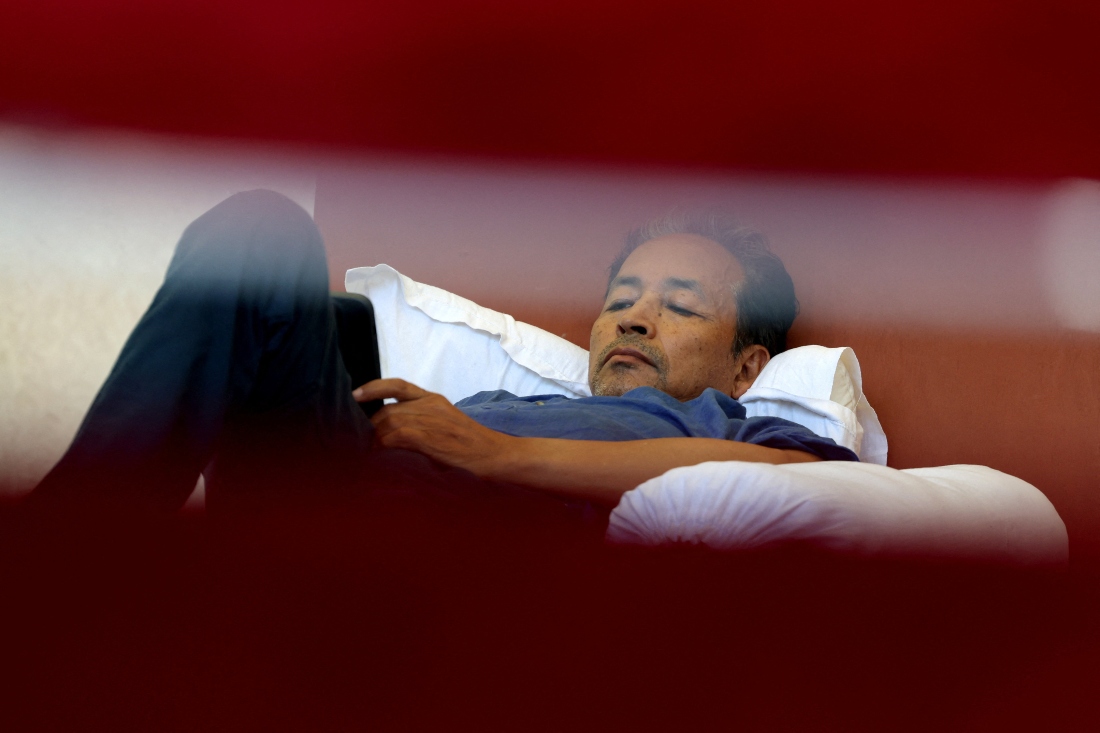 Sonam Wangchuk, an Indian education reformer who has been on hunger strike, rests on stage during a sit-in protest called by CJP demanding the resignation of Indian Education Minister Dharmendra Pradhan, at Jantar Mantar in New Delhi, India. (Reuters)
