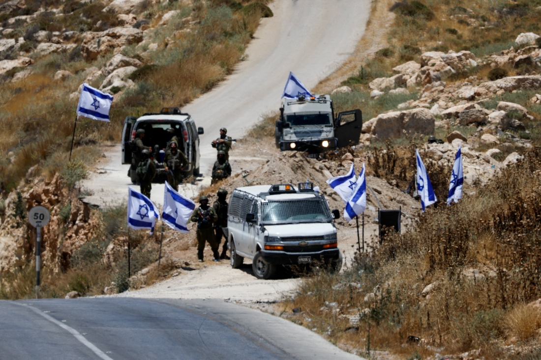 Israeli military block a road as Palestinians (not pictured) protest against settlement near Hebron, in the Israeli-occupied West Bank. (Reuters)