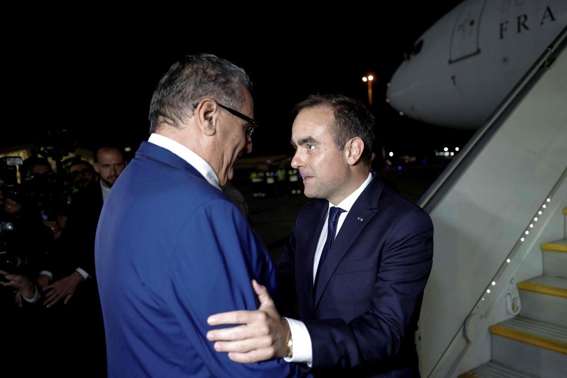 French Prime Minister Sébastien Lecornu (R) is greeted by Moroccan Prime Minister Aziz Akhannouch upon his arrival at Rabat-Salé Airport in Rabat on Jul. 15, 2026. (AFP)