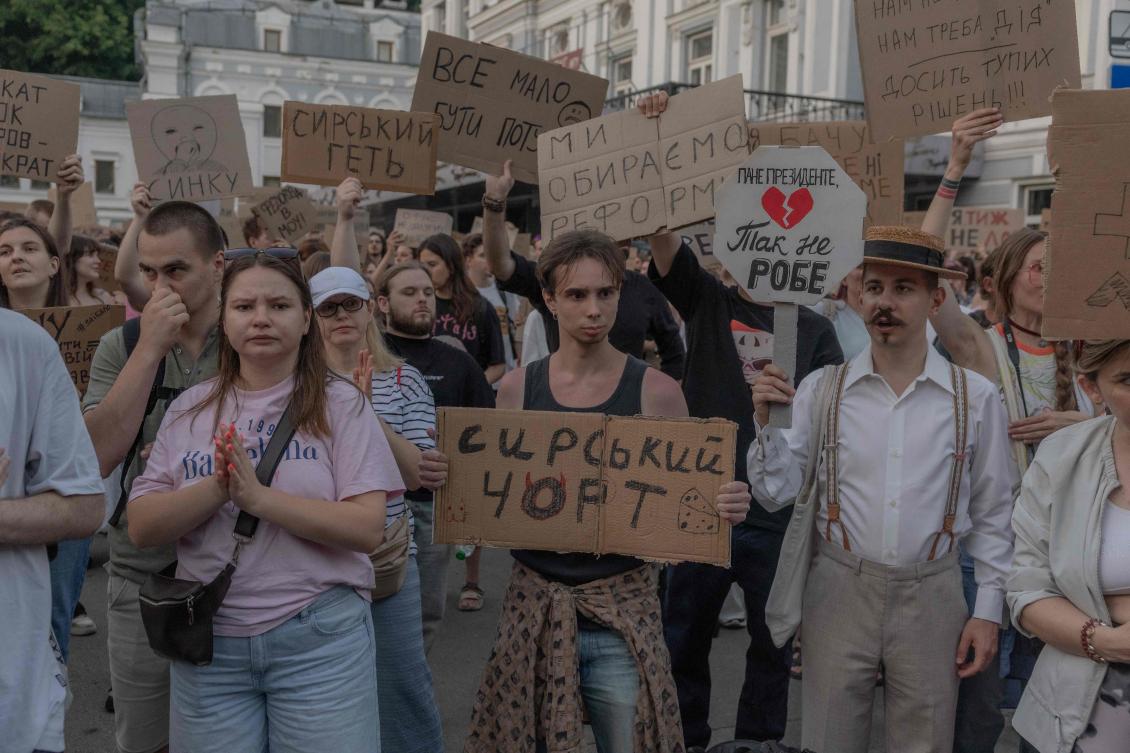 Protesters hold placards during a demonstration against Ukraine’s President Volodymyr Zelensky’s decision to dismiss Ukraine’s former defense minister Mykhailo Fedorov, in Kyiv on Jul. 16, 2026. (AFP)