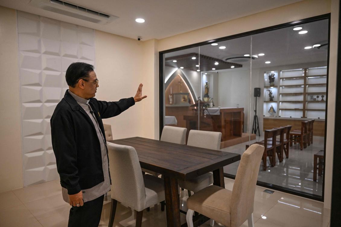 This photo taken on March 18, 2026, shows Father Jose Francisco Syquia gesturing towards the chapel used to conduct exorcism during a tour of the Saint Michael Center for Spiritual Liberation and Exorcism in Makati, Metro Manila. (Photo by Jam Sta. Rosa / AFP)