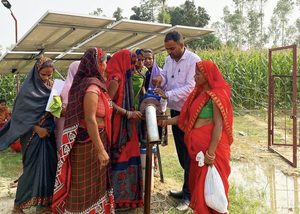 Women farmers gather to check a solar-power pump installed by Oorja Solutions in Bahraich district, Uttar Pradesh, January 2026. (Oorja Solutions)