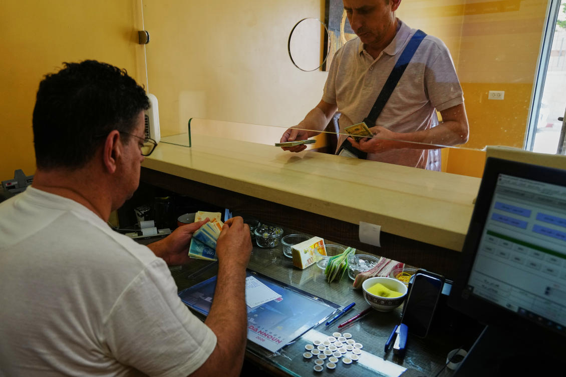 Above, a currency exchange employee counts Israeli Shekels at a bureau in the West Bank city of Bethlehem, Tuesday, July 7, 2026. (AP)