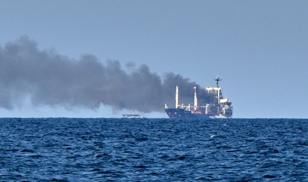 Smoke rises from the grain carrier MV Golden Leo, under the Guinea-Bissau flag, after a Russian missile strike in the Black Sea, close to Odessa, Ukraine, Sunday, July 19, 2026. (AP Photo)