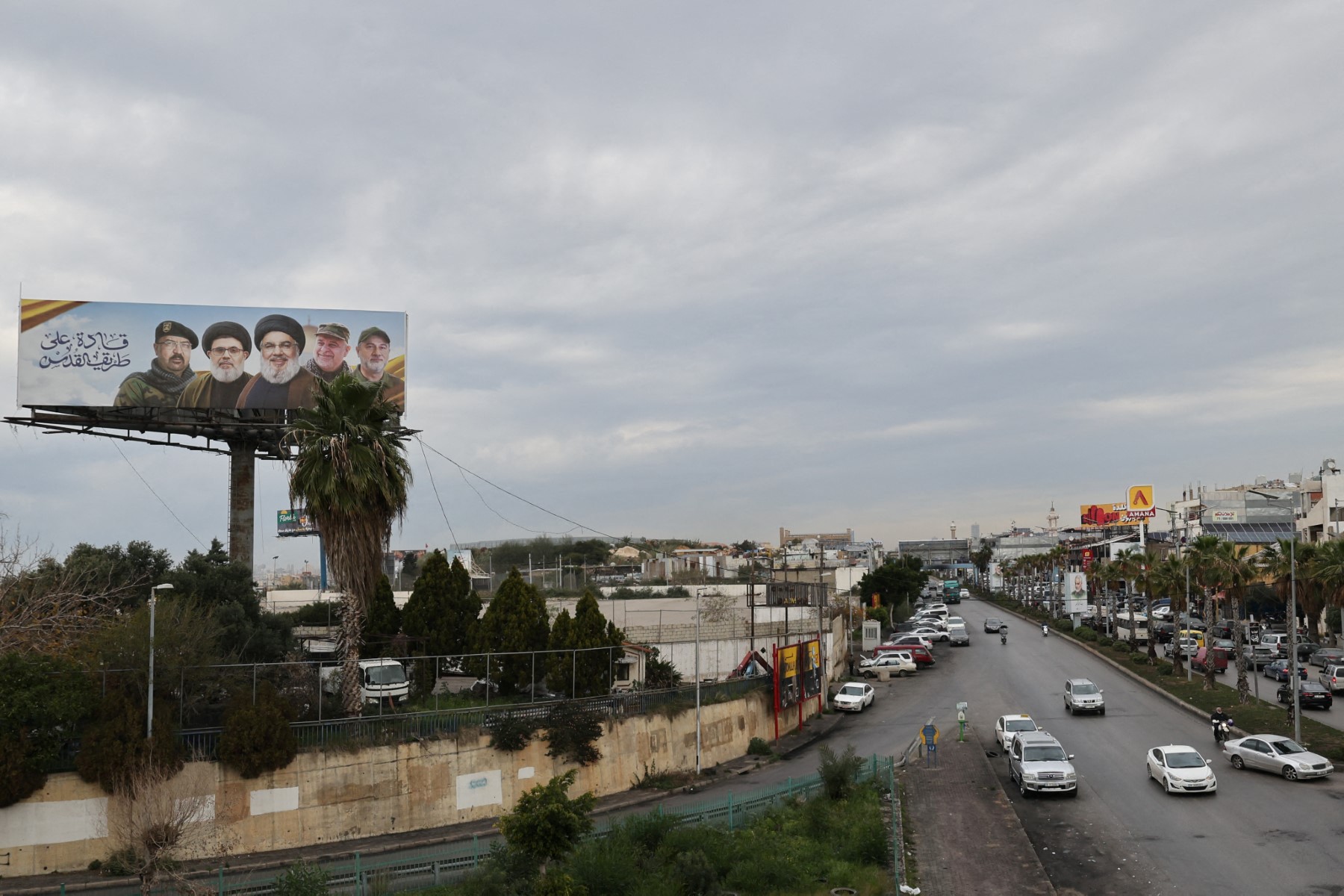 Banners depicting slain leader of the Lebanese Shiite Islamist movement Hezbollah Hassan Nasrallah (C) and his deputy Hashem Safieddine (C-L) and other slain Hezbollah commanders are displayed on Beirut Airport Road, in Beirut on February 19, 2025. (AFP)