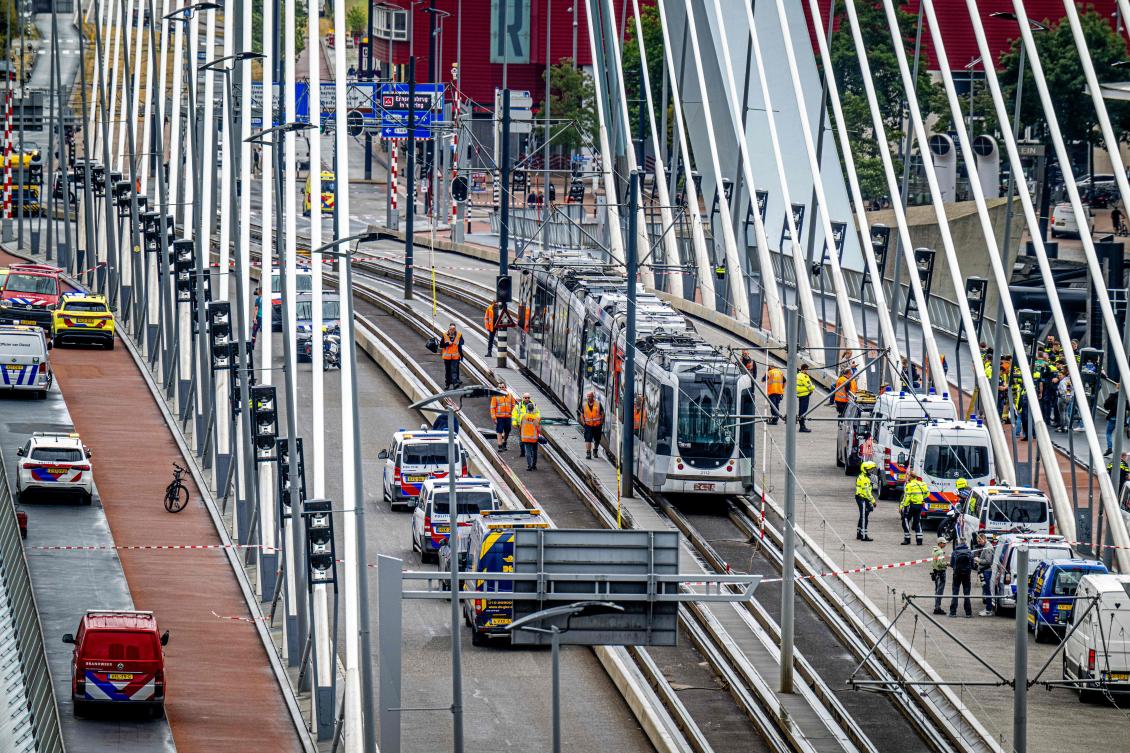 Firefighters and emergency services arrive on the site of an accident involving two trams that collided on the Erasmus Bridge, in Rotterdam on Jul. 22, 2026, injuring 18 people including two in serious conditions. (AFP)