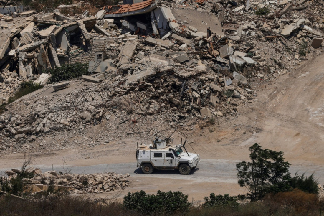 A United Nations Interim Force in Lebanon (UNIFIL) armoured vehicle driving past destroyed buildings in southern Lebanon on July 22, 2026. (File/AFP)