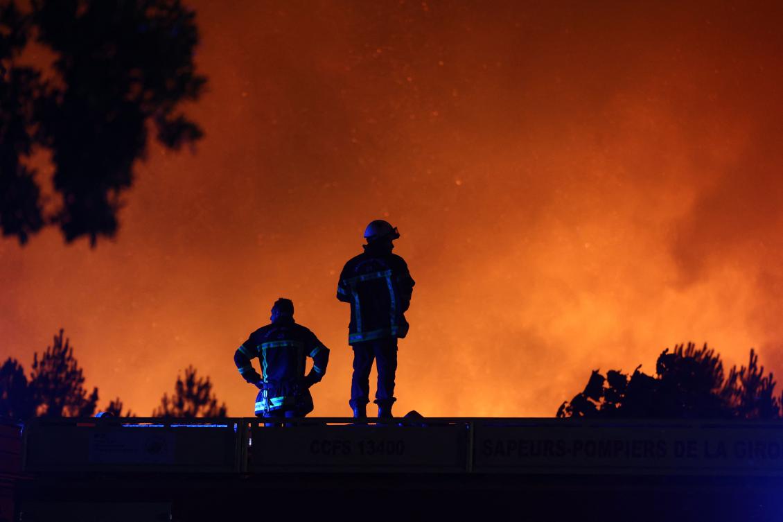 Firefighters monitor a wildfire in Le Porge, south-western France on July 22, 2026. (AFP)
