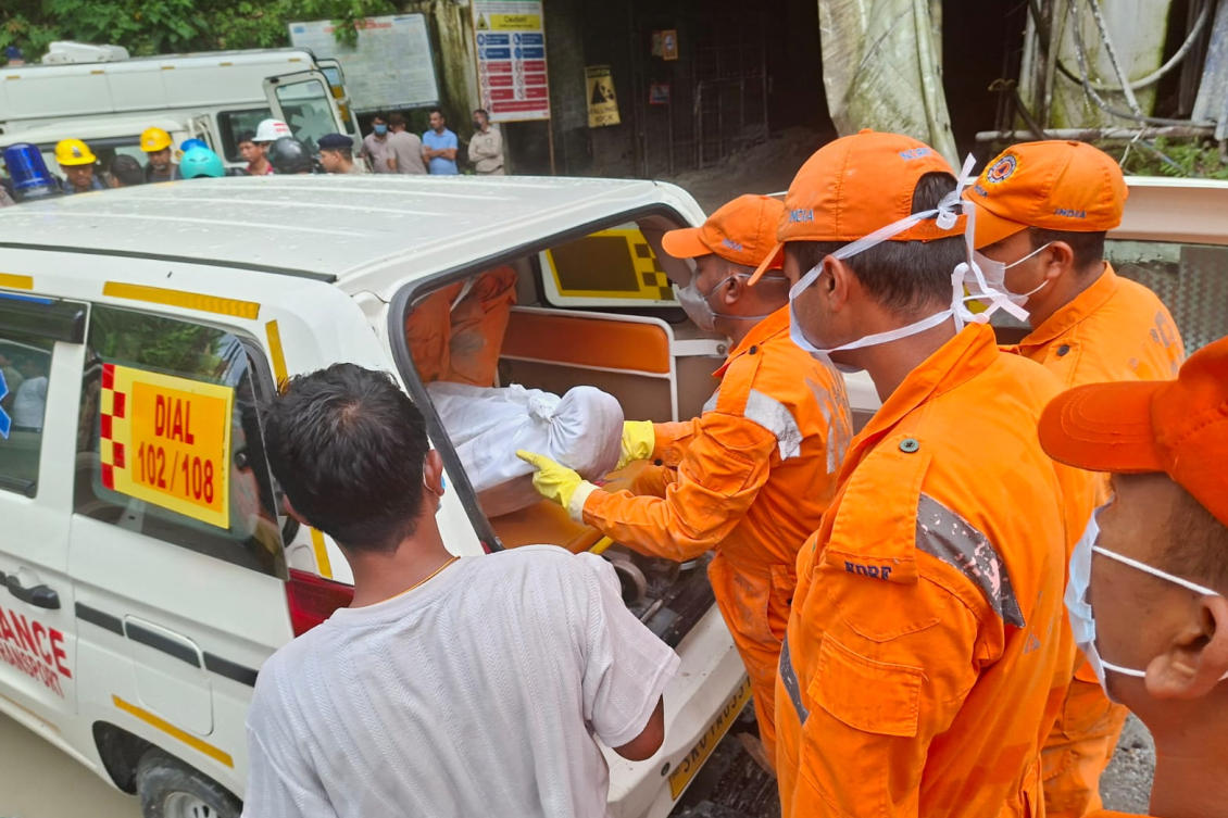 Rescue workers carry the body of a victim into an ambulance outside the entrance to an under-construction tunnel at a hydropower project in Samardung village, about 40 kilometers from Gangtok, Jul. 21, 2026. (AP)