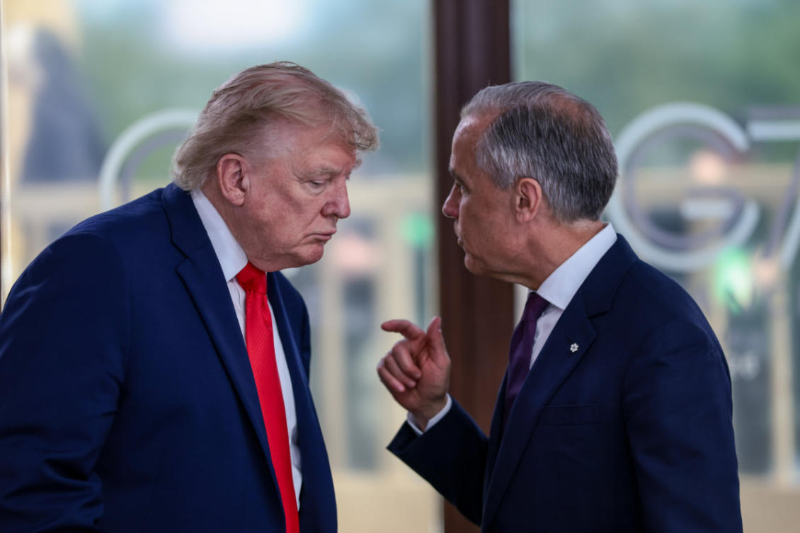 This photo taken on June 16, 2026, shows US President Donald Trump speaking with Canadian Prime Minister Mark Carney, right, at a working lunch with leaders of G7 and the Middle East in Evian-les-Bains, France. (Pool Photo via AP, File)