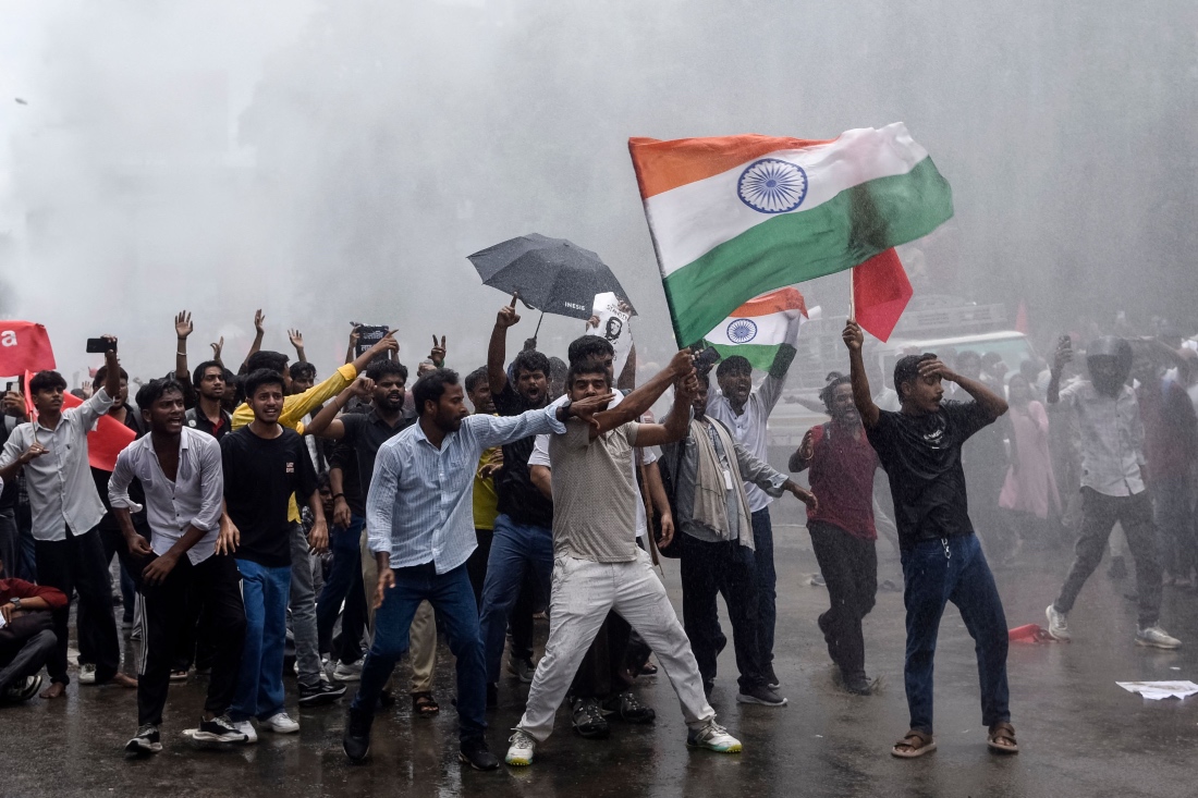 Demonstrators carrying the Indian national flag shout slogans during a protest march in Patna, India. (AFP)