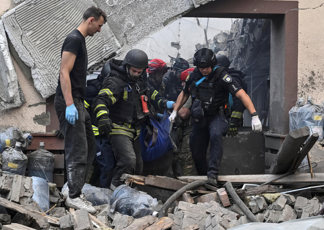 Rescuers and police officers carry the body of a killed resident at a site of the drinking water delivery company hit by a Russian air strike, amid Russia's attack on Ukraine, in Zaporizhzhia, Ukraine. (Reuters)
