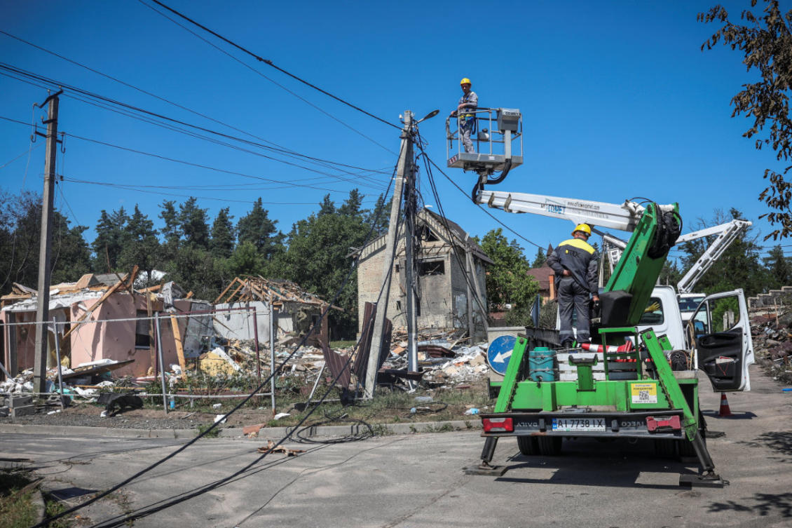Employees of DTEK energy company work to restore power supply after a residential area was hit by a Russian missile strike on the previous day in the Kyiv region, Ukraine, July 25, 2026. (Reuters)