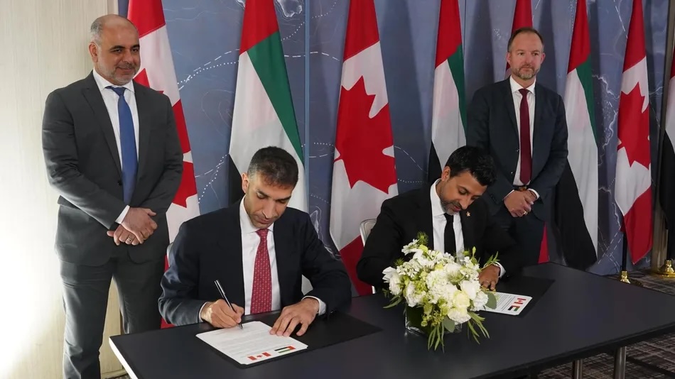 UAE Minister of Foreign Trade Thani bin Ahmed Al Zeyoudi and Canada's Minister of International Trade Maninder Sidhu sign the agreement. UAE Ministry of Foreign Trade